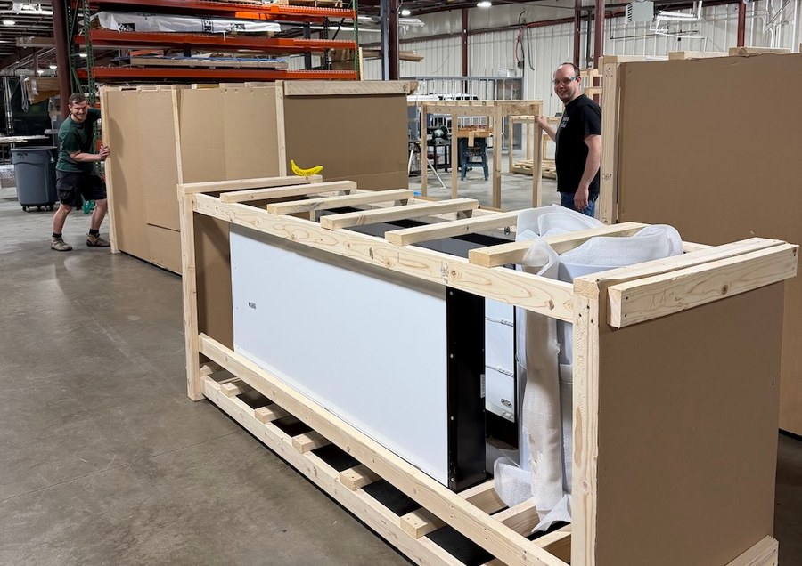 SignMonkey team crating a finished custom sign for shipment